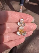 Found a silver enamel blossom earing