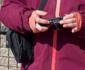 Small camera bag.
Inside: compact photo camera with two analog gauges on top.
In
