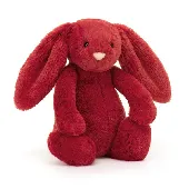 A red Jellycat bunny stuffed animal that belongs to my three-year-old daughter. 