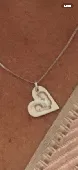 Silver heart shaped necklace with babies footprints engraved on
