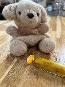 Small, light brown/golden dog (bear?) 

Label states “palm pals”
In very good co