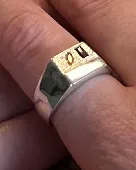 Square silver signet ring. Has two small stones, one orange, the other red.