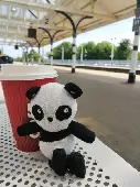 Stuffed toy Panda, about the size of a small hand. Label on his bum says Tesco, 
