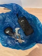 A pair of keys, a powerbank and bluetooth headphones