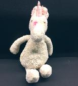 White Jellycat unicorn with distinctive markings found on the way to arrivals at