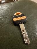 Found what looks like a car key,the fob is black with orange inlay with the lett