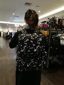 It’s a black backpack with pink floral patterns. There’s books notes wallet glas