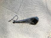 Lost a silver and black earring in car park in Woking