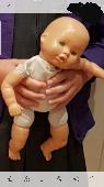 Lost. Much loved baby doll. Worn with a repaired arm and had no clothes on. Whit