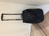 Black Eastpak cabin trolley bag. Contained books, files and computer. Some cloth