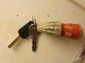 Set of two keys - possibly bike lock ones with a distinctive wooden key ring. Ke