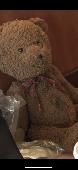Please see pictures of lost bear. Had glitter glue on his tummy and a red Christ
