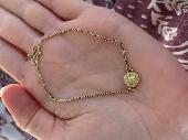 My boyfriend and I found a small gold bracelet with a circular disc with diamant