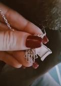 Hi, my husband lost my silver necklace with two pendants (One is a parchment wit