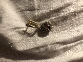 Round swarovski earring with beige and golden crystals on a golden buckle