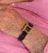 Rectangular told watch with black face and black strap. Strap could have come lo
