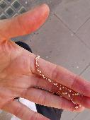 Found a short gold played necklace with white beads near Kensington Town Hall