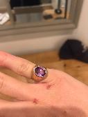 gold plated ring with purple stone.