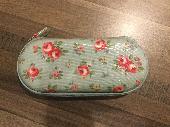 Glasses case containing black rimmed glasses