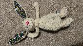 Very loved old and mended jellycat bunny with fabric mended ears and feet pads a