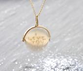 I lost a very sentimental gold necklace pendant. It’s a spinning disk that reads