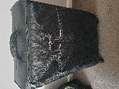 A black suitcase with men and women cloths in 