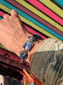 A Bracelet with different shaped pieces filled with Abalone shell, as seen in th