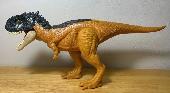 Medium size brown/beige/black dinosaur toy (skorpiovenator)