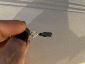 Lost part of an earring, a small white stone and a blue crystal drop. Somewhere 