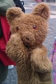 Arthur is a handmade teddy bear hand puppet, with orange eyes and a missing nose