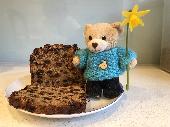 Small bear about 3 inches high. Wearing jeans and turquoise jumper with bear hea