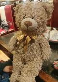 Brown bear with brown ribbon. Label with maker Jade Soft Toys, and hand written 