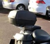Lost: a black top box from a motorcycle. Contains documents, motorcycle gear and