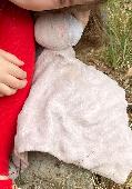 Pink handerchief bunny toy. Half a white face where it was mended.