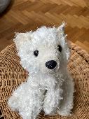 A white polarbear teddy with new fur attached to it, very loved. quite hard stuf