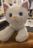 White cat, pink glitter ears. A bit worn out than the picture I have uploaded as