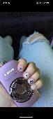 Purple digital camera (Canon Powershot). Inside a black case. On the side of the