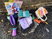 Just a backpack with some toys, clothes, and other stuff belonging to a child. P