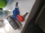 Black Honda Bike Key Fob with 3 keys and a silver Grenada bottle opener key ring