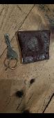 On pavement. Key in leather type pouch 